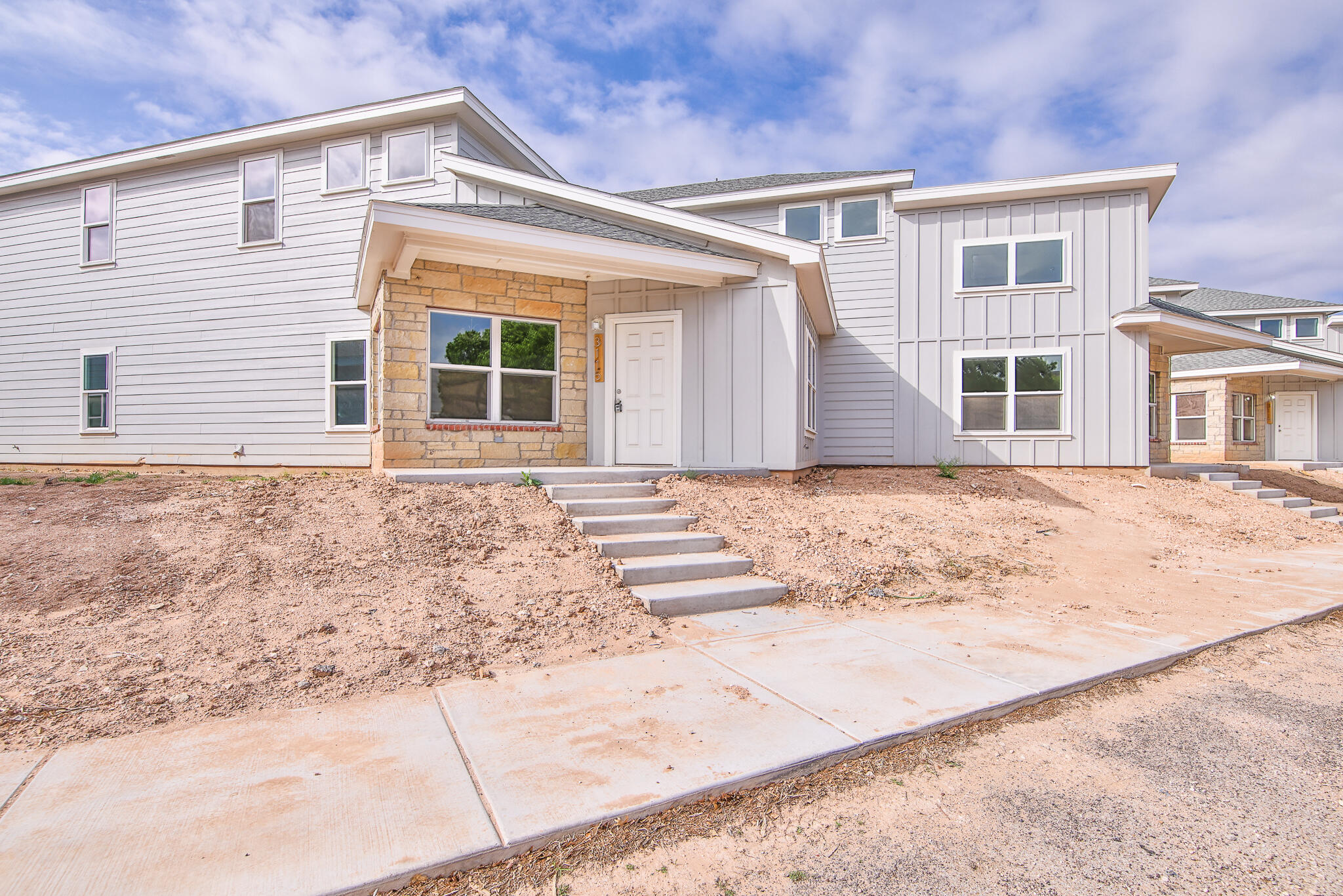 3115-3117 74th Street Lubbock, TX 79423 - Photo 2 of 37 a front view of a house with a yard