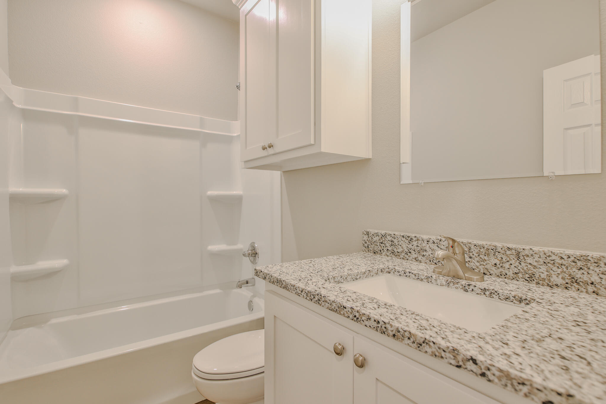 3115-3117 74th Street Lubbock, TX 79423 - Photo 22 of 37 a bathroom with a granite countertop sink toilet and bathtub