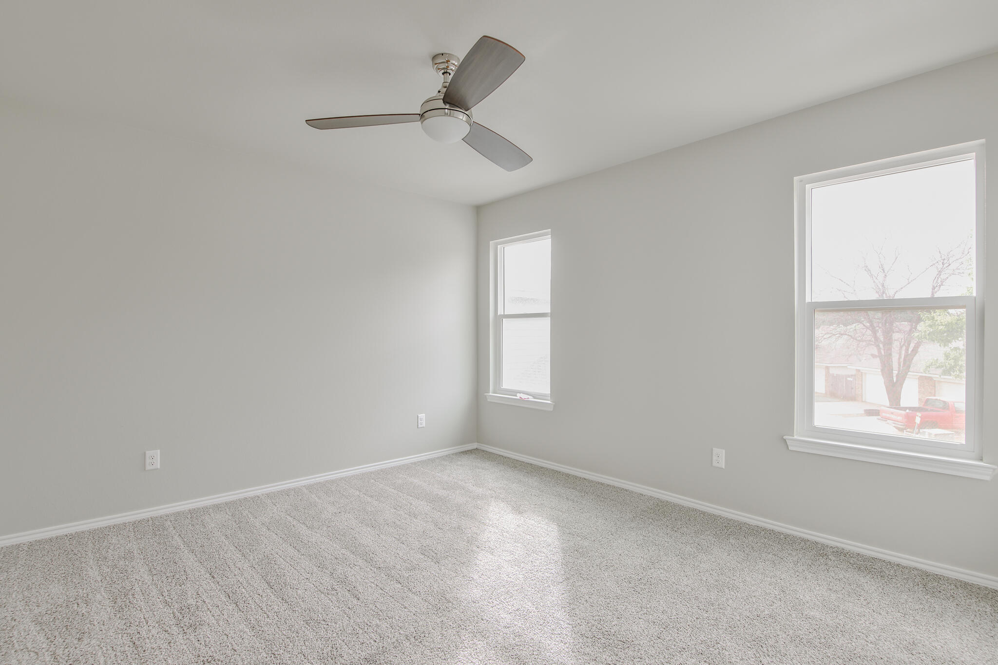 3115-3117 74th Street Lubbock, TX 79423 - Photo 33 of 37 an empty room with a window and ceiling fan