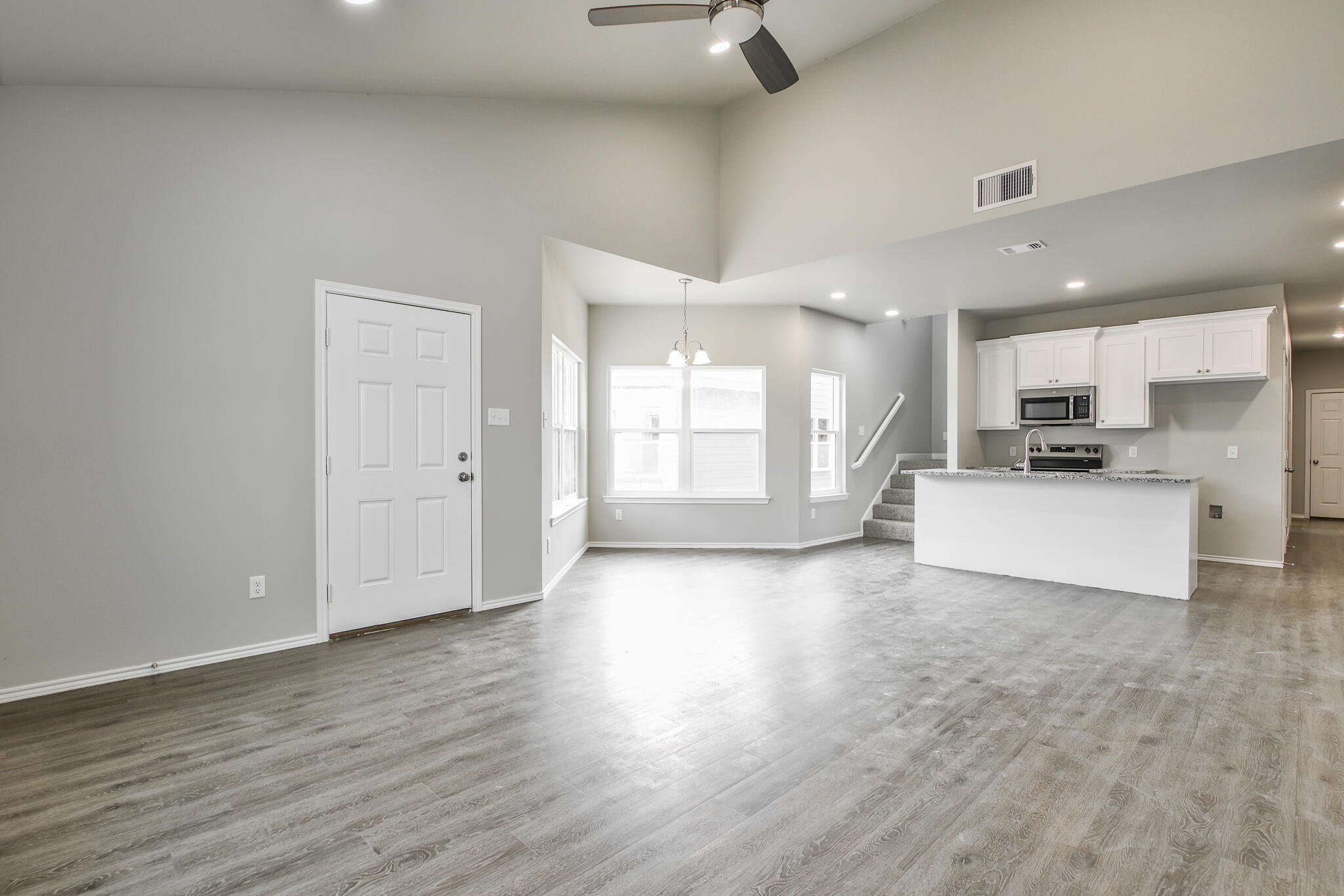 3115-3117 74th Street Lubbock, TX 79423 - Photo 5 of 37 a view of kitchen with furniture and wooden floor