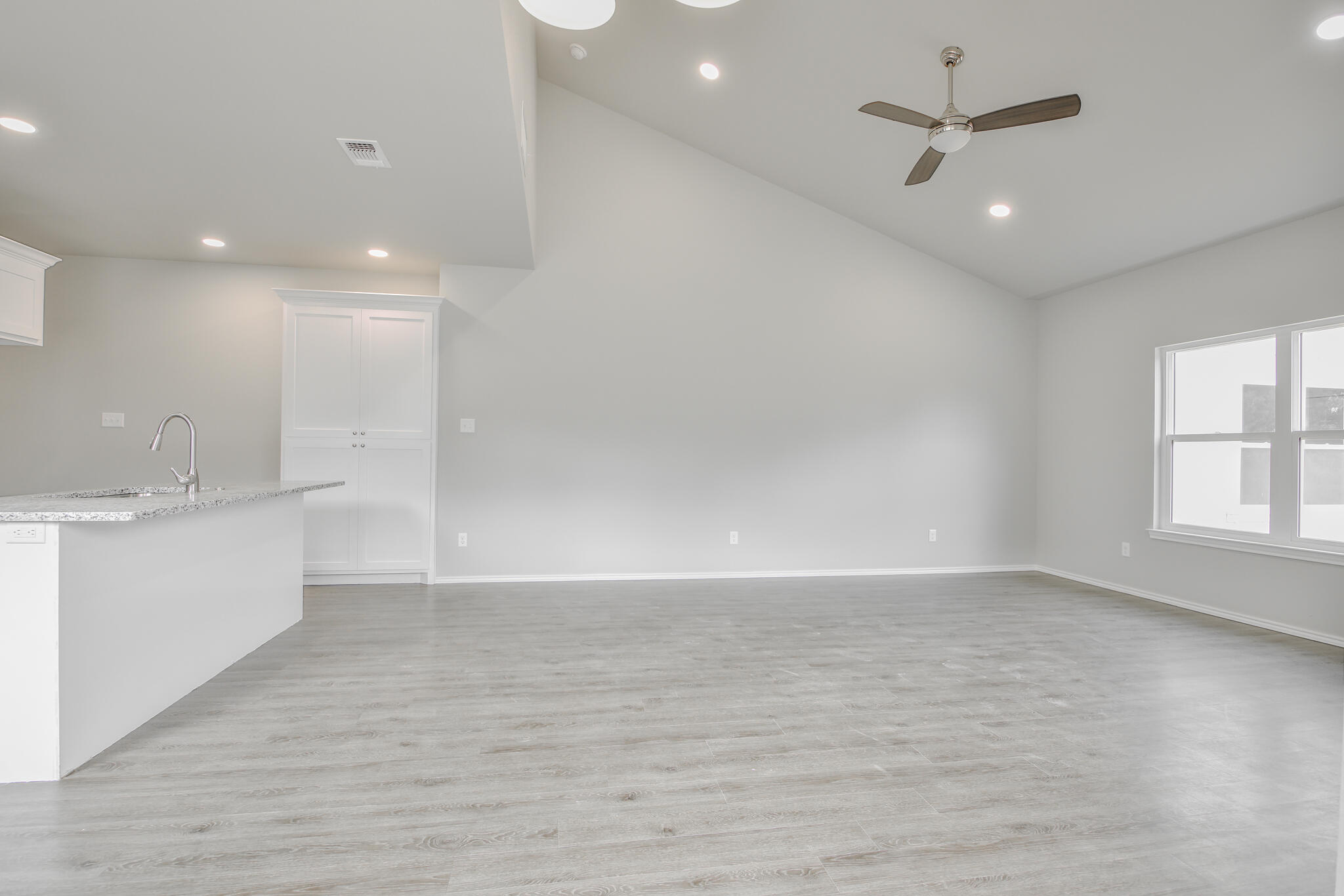 3115-3117 74th Street Lubbock, TX 79423 - Photo 6 of 37 an empty room with wooden floor and windows