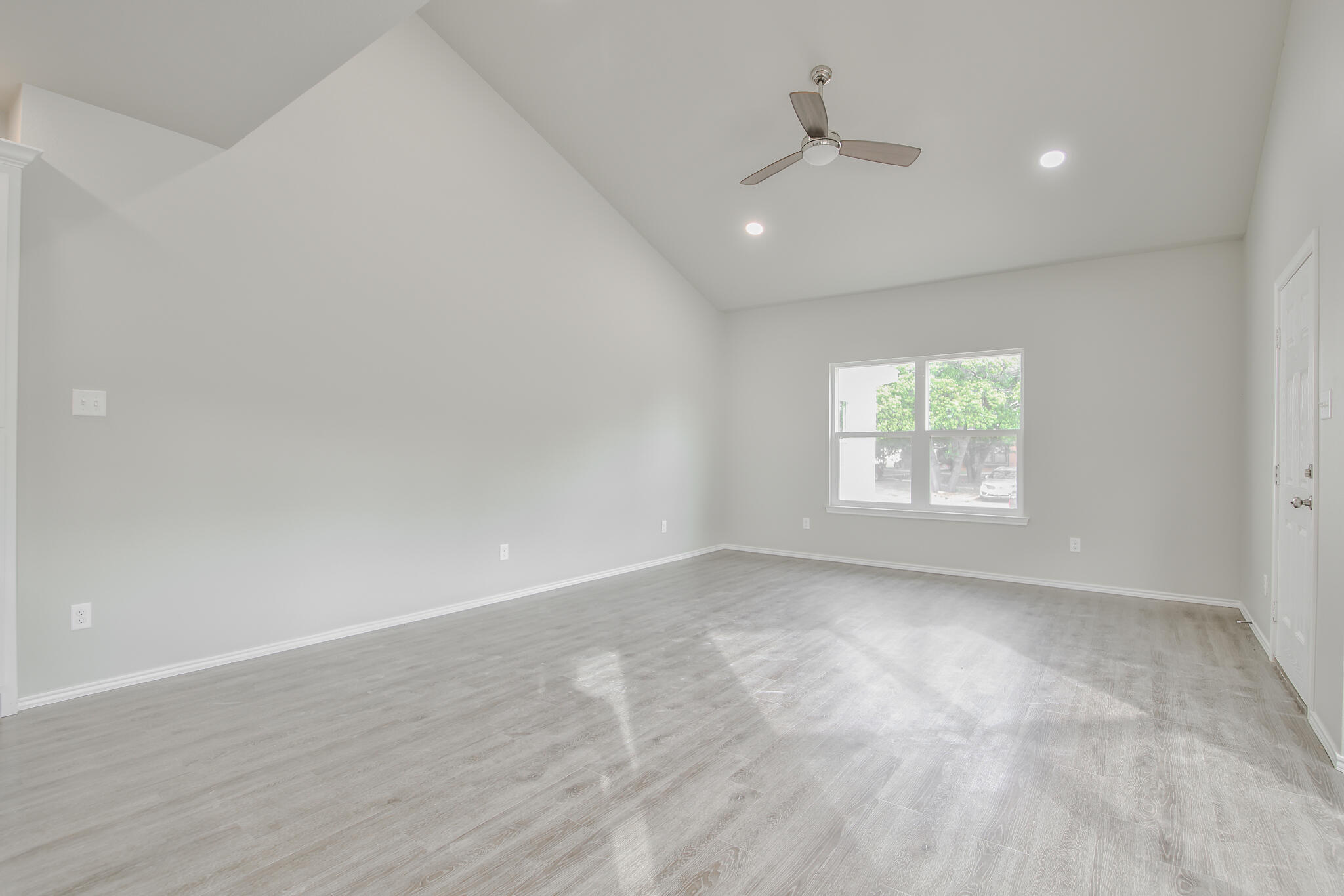 3115-3117 74th Street Lubbock, TX 79423 - Photo 7 of 37 an empty room with a window and a ceiling fan