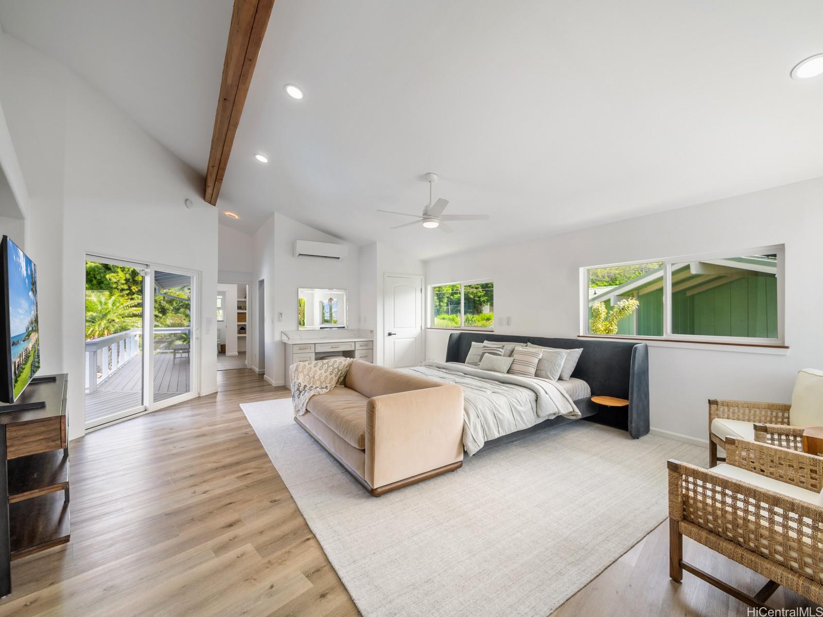 6815 Niumalu Loop Honolulu, HI 96825 - Photo 18 of 25 Primary Bedroom is expansive with vaulted ceilings, a large Walk-In Closet, adjacent en suite and access to the wraparound 2nd floor deck overlooking the Pool.