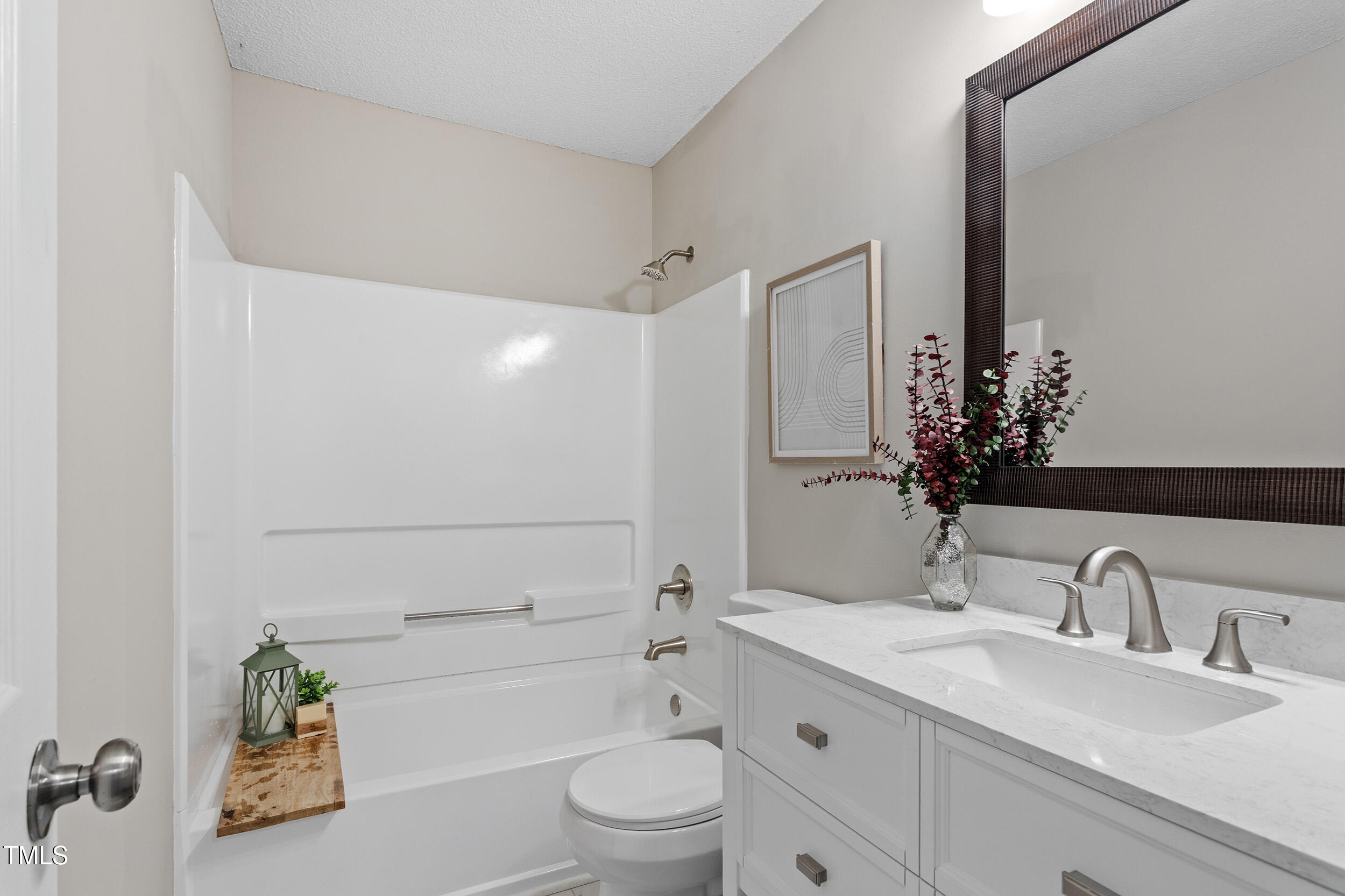4242 Kaplan Drive Raleigh, NC 27606 - Photo 7 of 30 a bathroom with a granite countertop sink a toilet and shower