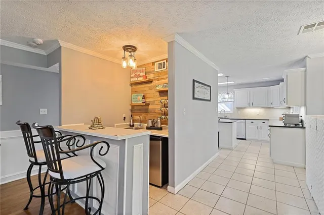 a kitchen with kitchen island a stove a table and chairs in it