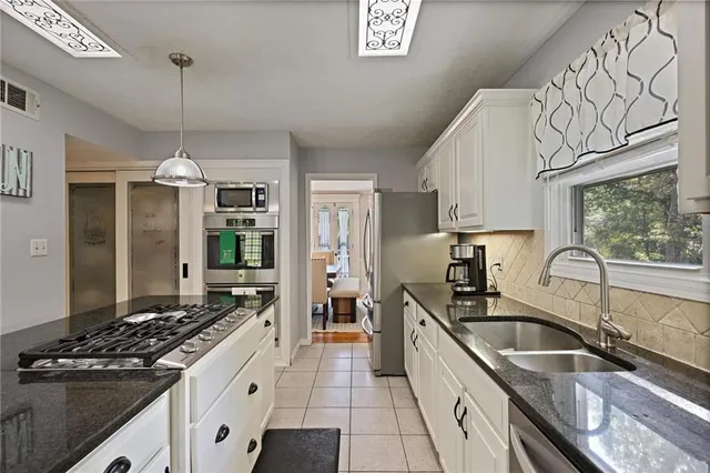 a kitchen that has a sink stove and cabinets