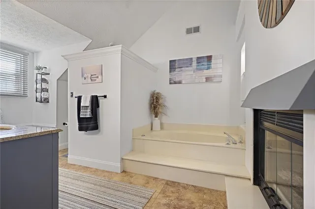 a bathroom with a bathtub and a shower