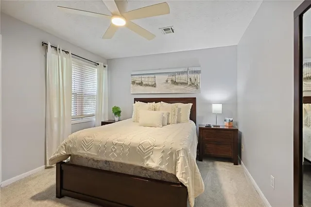 a bedroom with a bed and a night stand