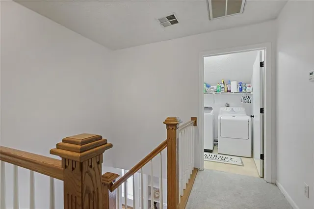 a view of a hallway to a livingroom with furniture