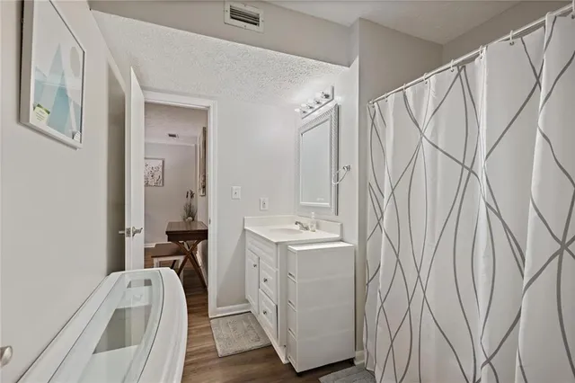 a view of a bathroom with tub and sink