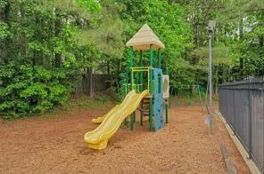 a view of a wooden deck and a backyard