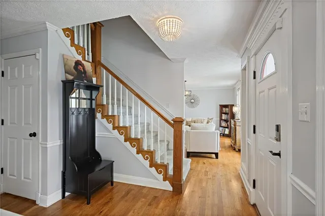 a view of entryway and hall with wooden floor