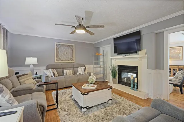 a living room with furniture a fireplace and a flat screen tv