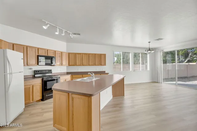 a spacious bathroom with a double vanity sink a mirror and a shower