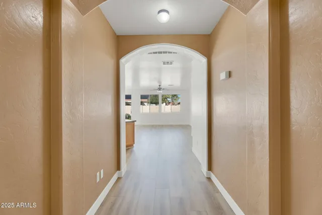 a kitchen with stainless steel appliances granite countertop a kitchen island a stove a sink dishwasher and cabinets with wooden floor