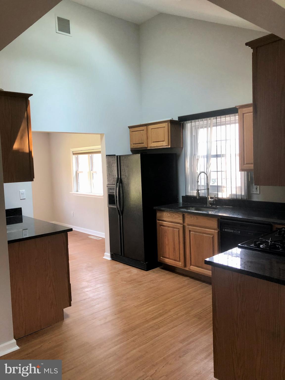 404 Flanders Road Bellmawr, NJ 08031 - Photo 5 of 19 a kitchen with granite countertop a refrigerator stove and sink