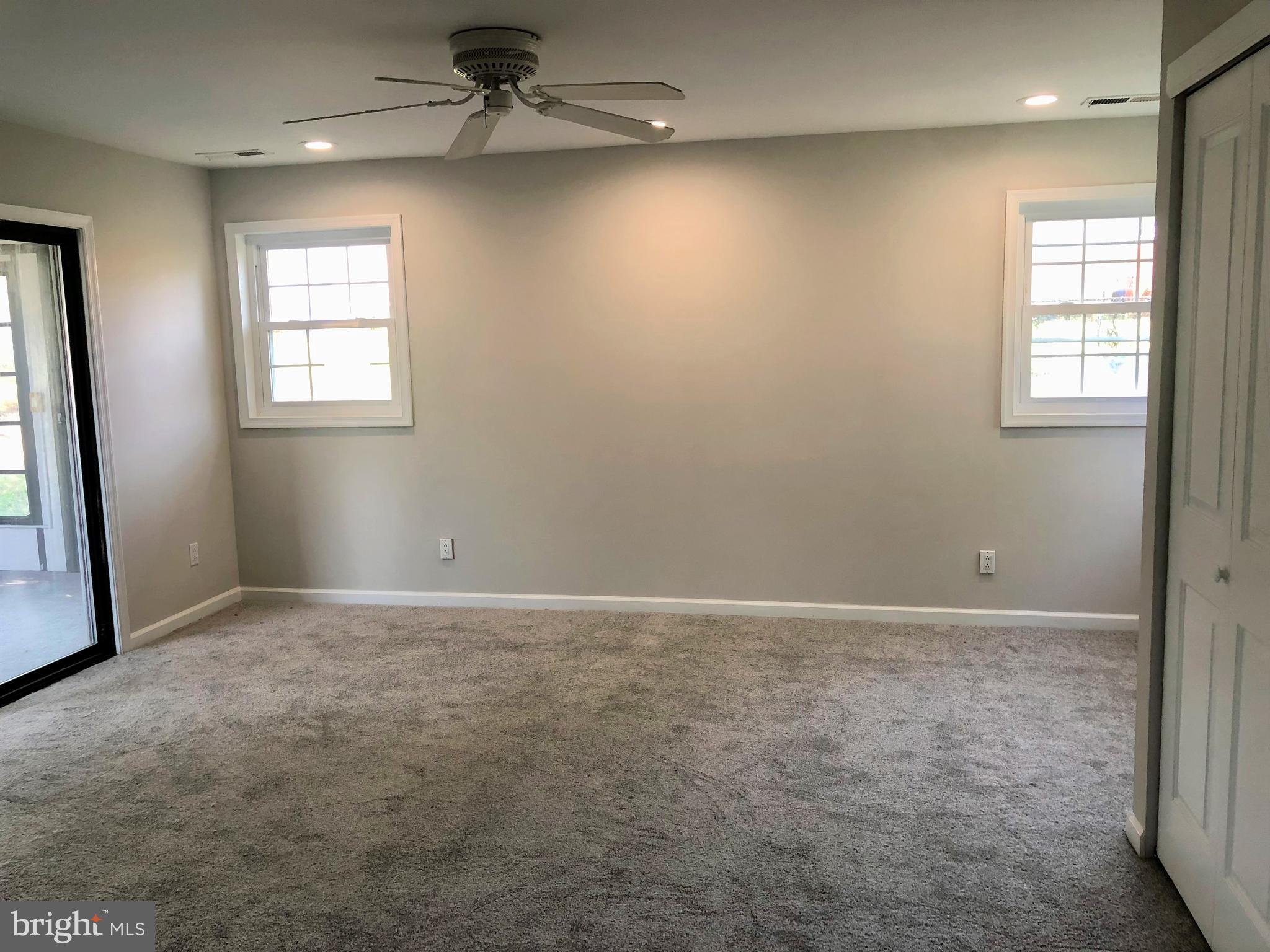 404 Flanders Road Bellmawr, NJ 08031 - Photo 8 of 19 an empty room with windows and fan