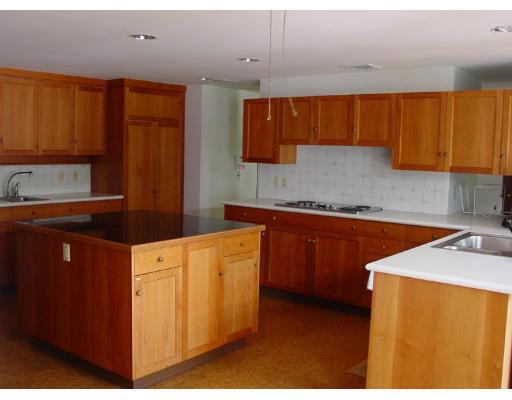 35 Bowditch Road Sudbury, MA 01776 - Photo 7 of 12 a kitchen with stainless steel appliances granite countertop a sink stove and cabinets