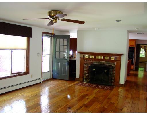 35 Bowditch Road Sudbury, MA 01776 - Photo 8 of 12 a view of an empty room with a fireplace and a window