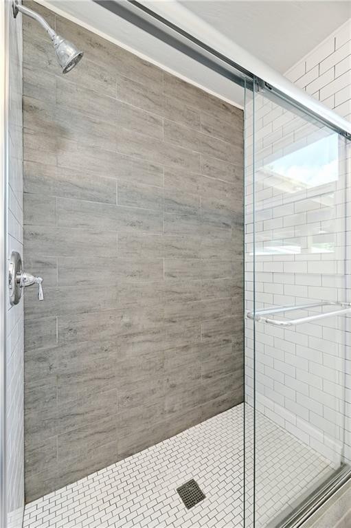 8318 Burrell Drive Austin, TX 78757 - Photo 16 of 27 Full bathroom featuring a shower stall
