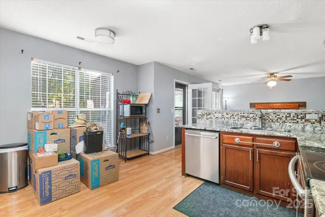 a kitchen with stainless steel appliances granite countertop a stove and a refrigerator
