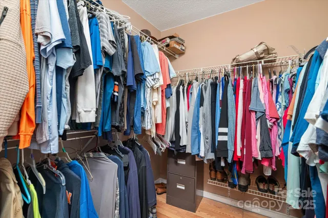 a view of walk in closet with clothes