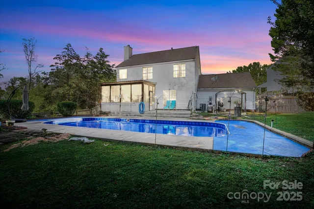 a view of an house with backyard and outdoor seating
