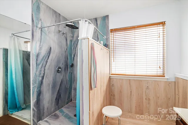 a bathroom with a shower and a glass door