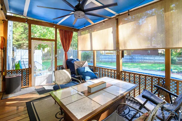 a living room with furniture and a floor to ceiling window