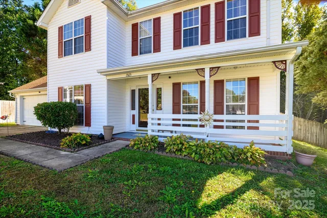 a view of a house with a yard and table and chair in patio