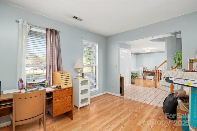 a bedroom with furniture and a large window