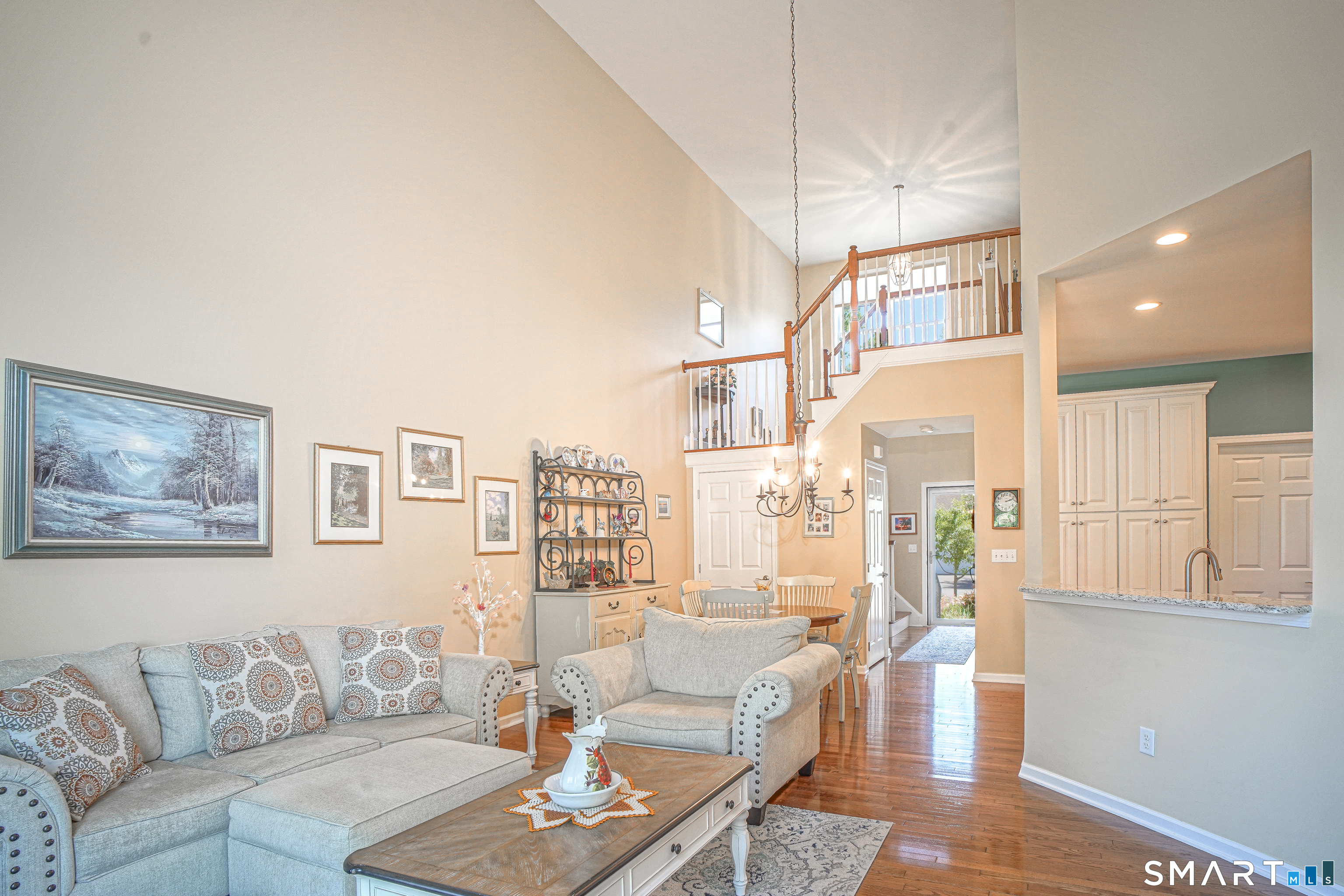 6 Lilac Lane, Unit 6 Prospect, CT 06712 - Photo 36 of 40 Open floor plan with high ceilings and views of the railing to the upper level. All with hardwood floors