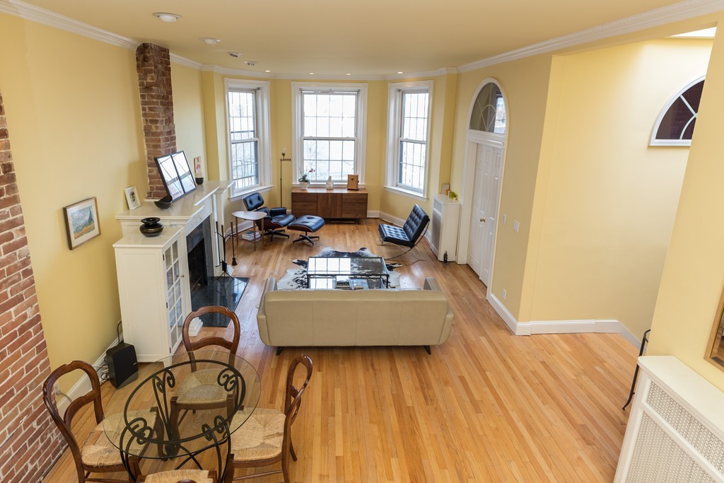 37 Bay State Road, Unit 6 Boston, MA 02215 - Photo 12 of 25 a living room with furniture and a wooden floor