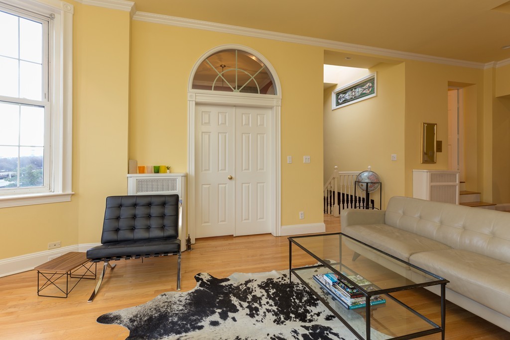37 Bay State Road, Unit 6 Boston, MA 02215 - Photo 14 of 25 a living room with a couch and a window