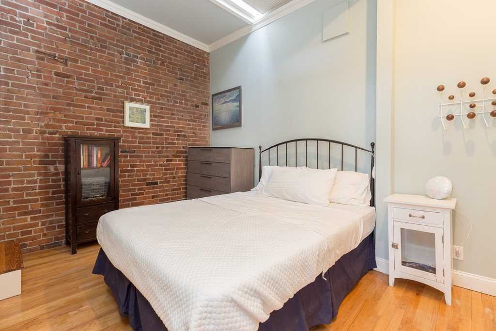 37 Bay State Road, Unit 6 Boston, MA 02215 - Photo 17 of 25 a bedroom with a bed and a table