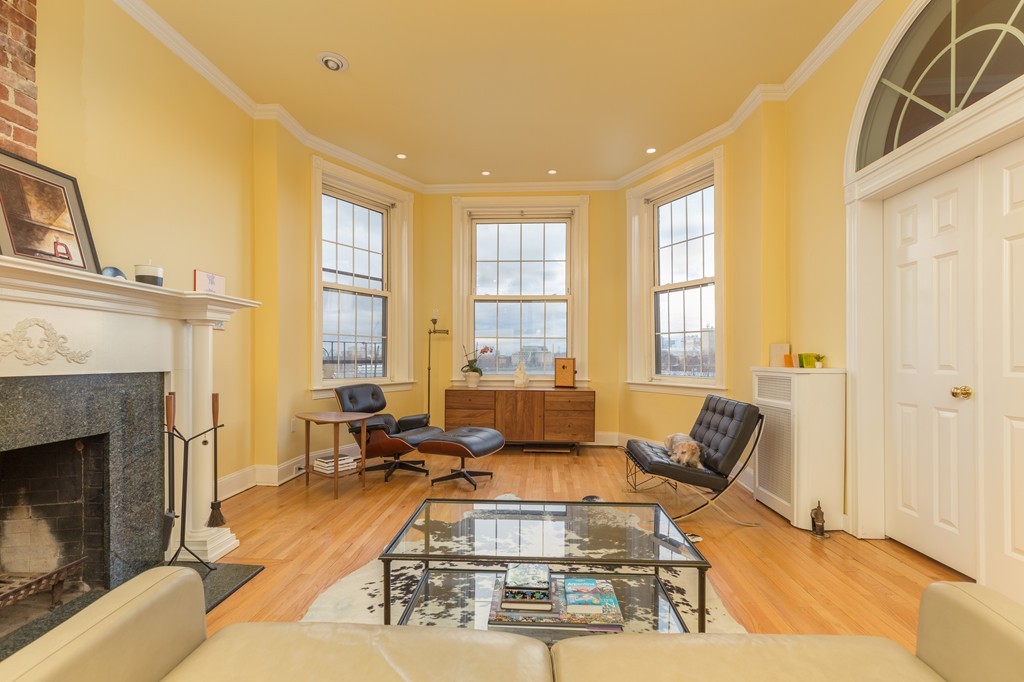 37 Bay State Road, Unit 6 Boston, MA 02215 - Photo 2 of 25 a living room with furniture large window and a fireplace