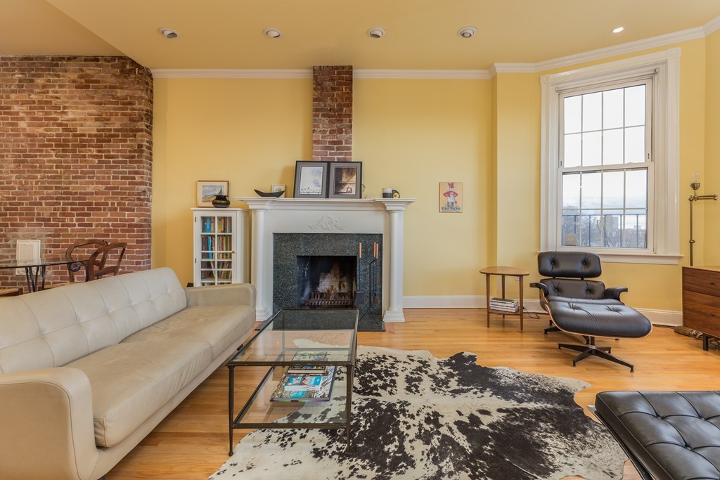 37 Bay State Road, Unit 6 Boston, MA 02215 - Photo 6 of 25 a living room with furniture a rug and a fireplace