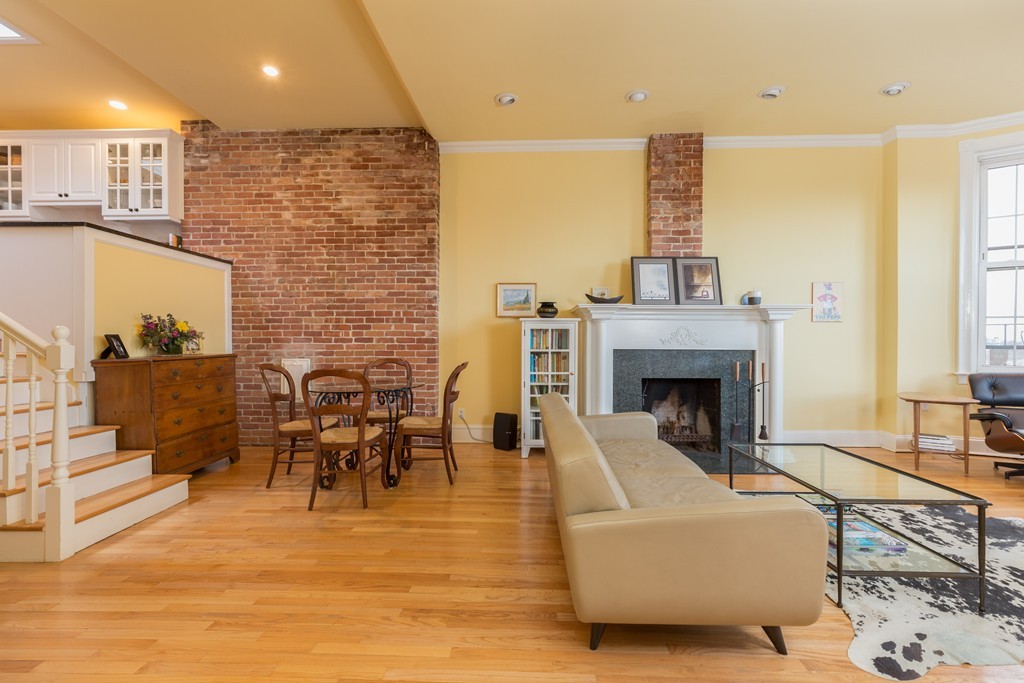 37 Bay State Road, Unit 6 Boston, MA 02215 - Photo 7 of 25 a living room with furniture a fireplace and a flat screen tv