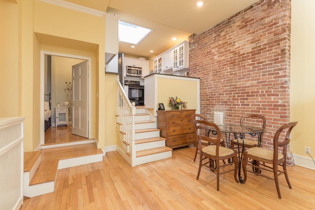 37 Bay State Road, Unit 6 Boston, MA 02215 - Photo 9 of 25 a view of a livingroom with furniture and stairs