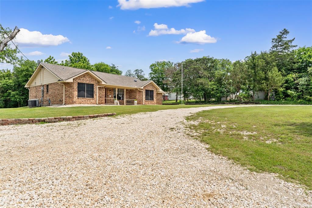 162 High Ridge Drive Bruceville, TX 76630 - Photo 5 of 40 a front view of a house with a yard and potted plants