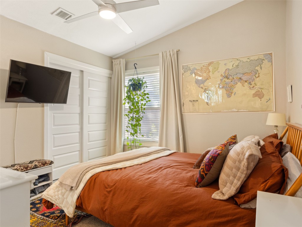 1307 East St Johns Avenue, Unit B Austin, TX 78752 - Photo 14 of 27 a bedroom with a bed and a flat screen tv