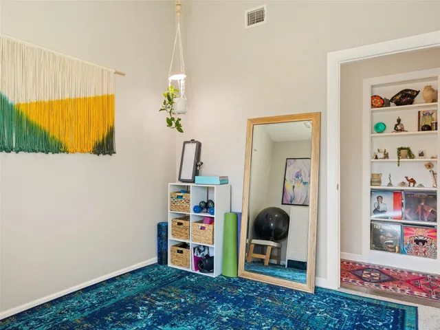 a view of a bedroom with baby crib and toys