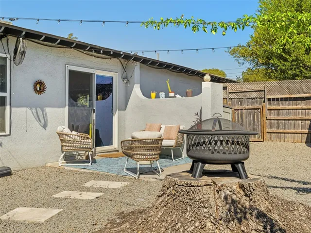 a view of a patio with a table and chairs