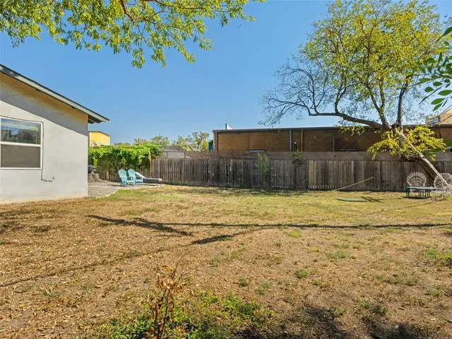 a swimming pool with outdoor seating and yard