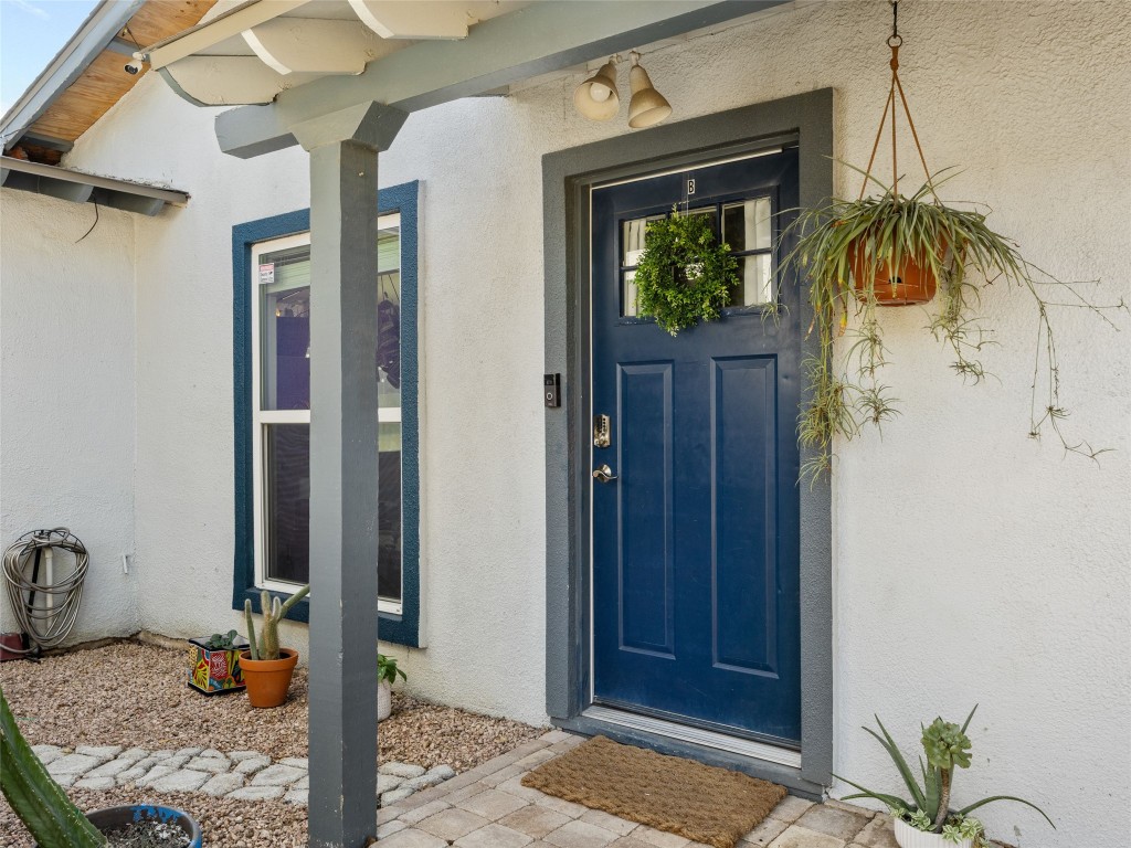 1307 East St Johns Avenue, Unit B Austin, TX 78752 - Photo 3 of 27 a bathroom with a granite countertop sink and a mirror