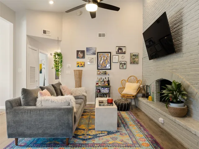 a living room with furniture a flat screen tv and a fireplace