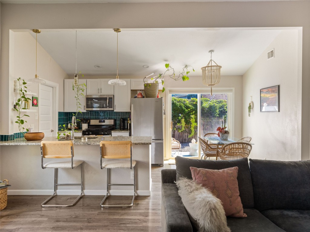 1307 East St Johns Avenue, Unit B Austin, TX 78752 - Photo 7 of 27 a living room with furniture and a kitchen area