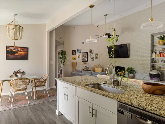 a kitchen with sink cabinets and dining table