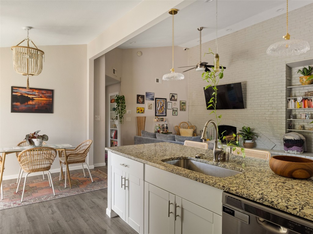 1307 East St Johns Avenue, Unit B Austin, TX 78752 - Photo 10 of 27 a kitchen with sink cabinets and dining table