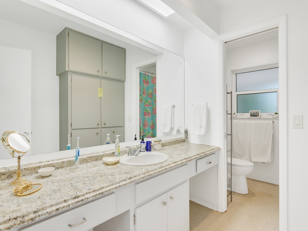 546-556 Azalea Lane Vero Beach, FL 32963 - Photo 11 of 18 a bathroom with a granite countertop sink and a mirror